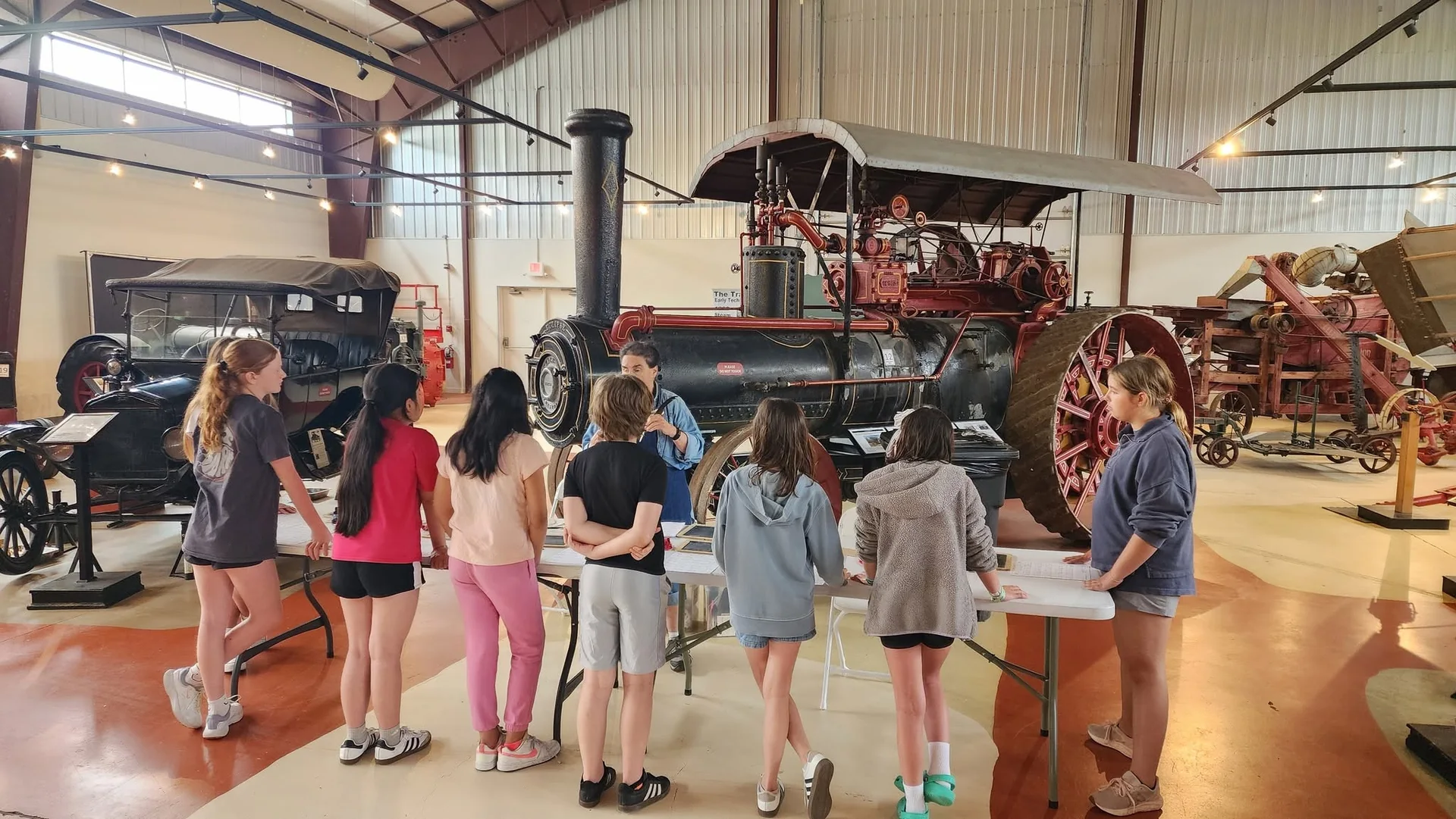 Students learning about a historic steam tractor at the Delaware Agricultural Museum